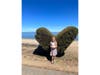 Posing in front of a topiary heart on Bay Farm Island.
