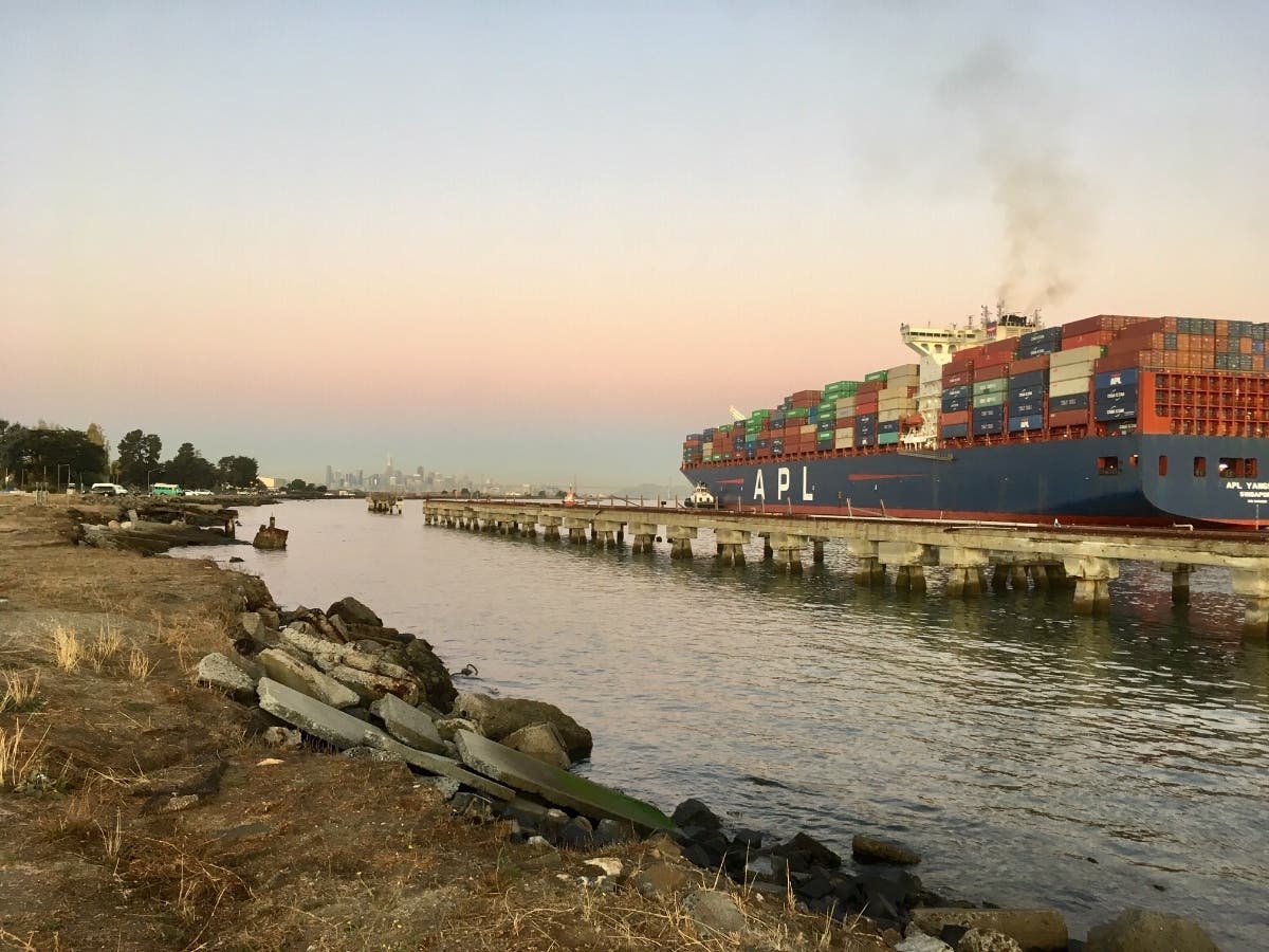 A container ship leaves the loading dock at the Port of Oakland, Calif. Nov. 2019.