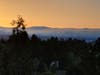 At dusk, fog clears the coastal range and creeps over the San Francisco Peninsula.