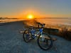 A bike ride paused to enjoy the sunrise.
