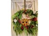 This wreath is decorated with freshly cut greenery.