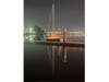 A sailboat docked at night.
