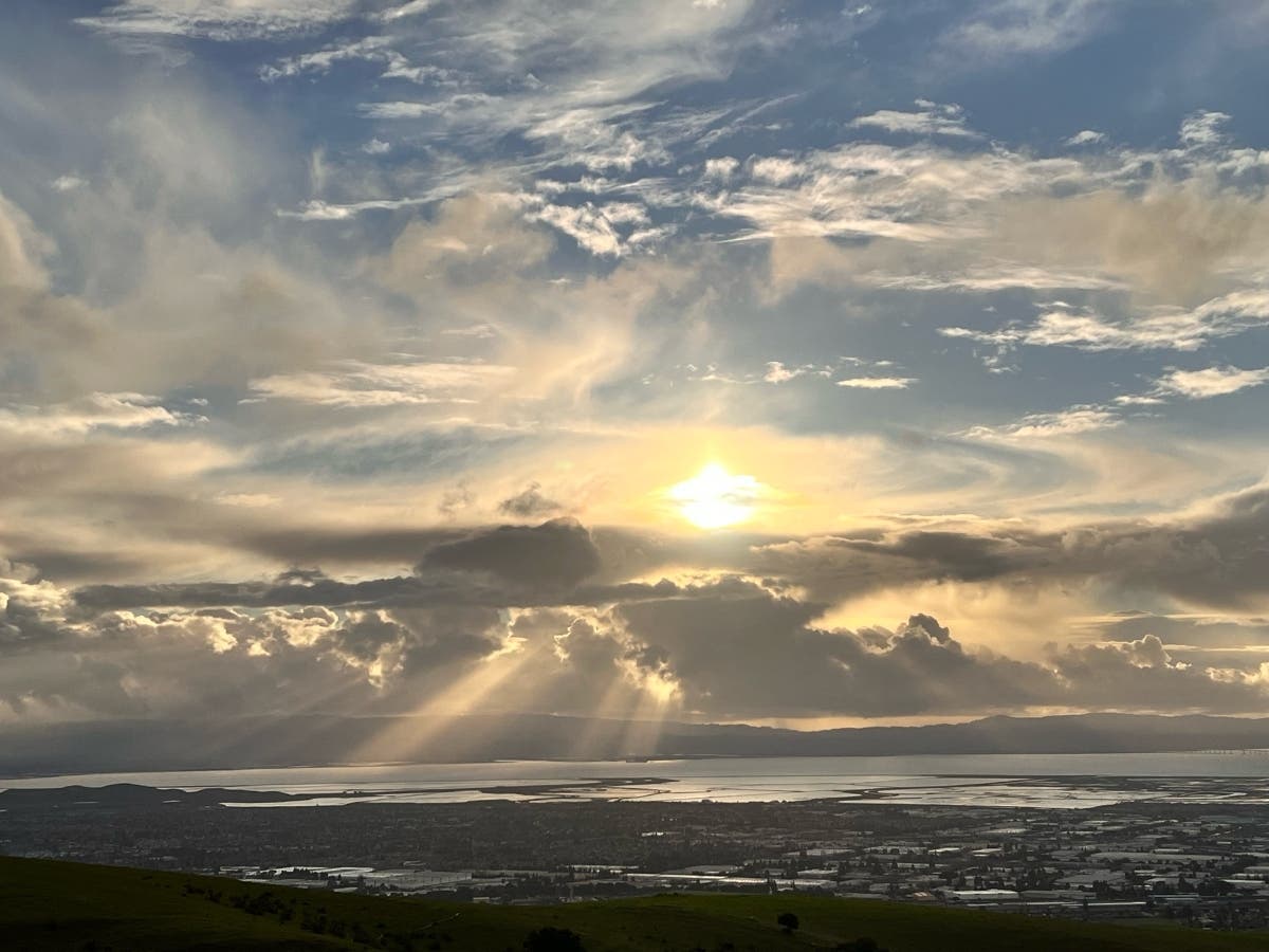 Sunbeams stream down from the clouds over San Francisco Bay.