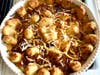 Veggie Tots Casserole with corn, spicy chili, cheese, and veggie tots. To be served with sliced avocado, pickled jalapenos, and dots of sour cream.
