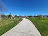 A wide paved path to the playground in Central Park in Fremont, Calif.