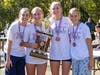 The JV Lady Eagle top-runners receiving their winning team trophy. (l-r) Senior Shelby Howerton, freshman Macy Schadt, senior captain Ellie Dickenson & freshman Ivy Rindt.