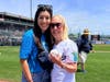 Director Lisa Buonomo and Executive Director Kathy Feigley receive the ceremonial  first pitch ball