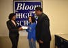 Devin Maddox presents the check to Bloom High School's Elizabeth Fushi and Dr. Lenell Navarre 