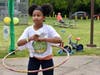 Taking part in a hula hoop contest during the 32nd Annual Commissioners Park Bike Rodeo
