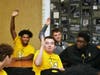 A few of the Marian Catholic varsity football players raise their hands in a question posed to them by Dennis McKinnon