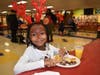 Dressed in her reindeer best, Tim`Mya Shy (5) enjoys her pancake breakfast at Bloom Trail