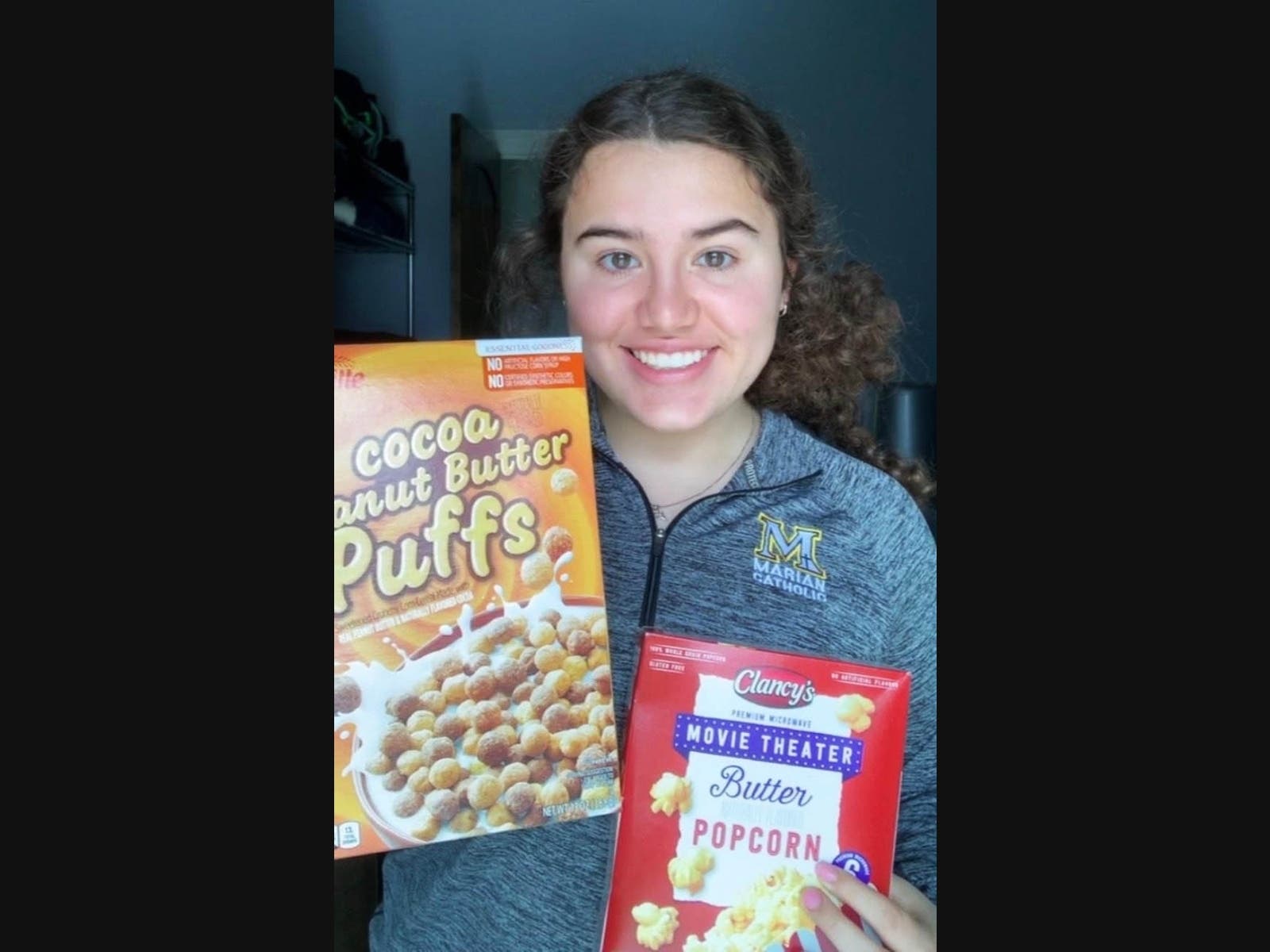 Karina Bonilla, a student at Marian Catholic holds a few donations shown that she is asking for a food drive she has organized at the high school. 