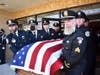Police officers, carry the body of Chicago Heights police officer, Gary Hibbs into St. Kieran church in Chicago Heights. Police officers were all friends of Officer Hibbs. 
