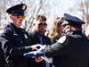 Tommy Rogers, Chicago Heights Chief of Police (right) presents an American flag to Chicago Heights police officer Jimmy Hibbs during the funeral of his father. Hundreds of police officers took part in escorting Officer Gary Hibbs body. 
