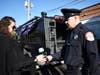 Jimmy Hibbs, a Chicago Heights police officer, gives his sister, Esther Hibbs Barker a blue rose during the funeral of their father, Gary Hibbs. 