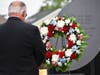 Terry L. Matthews, Village President of South Chicago Heights places the wreath to remember the veterans from South Chicago Heights who were killed in action.