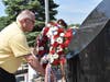 Terry L. Matthews, Village President of South Chicago Heights places a memorial wreath during the annual Memorial Day Ceremony.