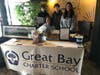 Great Bay Charter School Boosters members Meredith Pool and Melanie Niemi along with 8th graders Kyle and Noah Pool, at the silent auction table during a recent benefit for the charter school.  