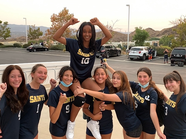 Hoisted by some teammates, Liyat Belay celebrates a win helped by her unusual serve.