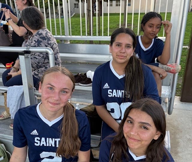 Sophia Aguilar in the middle of her female teammates at Lighthouse Christian Academy of Santa Monica