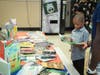 A young boy reads one of the 3,000 books donated to the Uniondale School District from the Book Fairies.