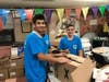 Two eighth grade students from the Silverstein Hebrew Academy packing up boxes of food to be distributed to families in need for the Rosh Hashanah holiday.