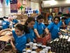 Students packing various non-perishable food items into boxes for less fortunate families in the New York metropolitan-area.  