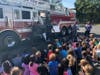 Volunteer members of the Plainview Fire Department Truck Company 2 greet students in grades K-4 at the Plainview-Old Bethpage Central School District’s Judy Jacobs Parkway Elementary School. 