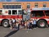 Valley Stream Union Free School District Thirteen James A. Dever Elementary students standing in front of Malverne Volunteer Fire Department Engine 432 truck.