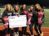 Plainview-Old Bethpage John F. Kennedy High School DECA students and DECA Advisor Lindsay DeLucca presenting Stacy Brennan with a check for $7,000 that students and faculty raised together for a variety of cancer research and awareness organizati