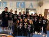 Plainview-Old Bethpage John F. Kennedy High School DECA Club and DECA advisor Lindsay DeLucca wearing their Coaches vs. Cancer shirts in support of breast cancer research and awareness. 