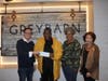 Greybarn Community Director Michael Loeffler (left) and Director of Corporate Housing Claudia Mazzola (right) present a donation to Pastor Roy Kirton of the Circle of Love Ministry to facilitate the assembly of more than 2,000 dinners. 