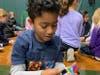 An East Woods School student showing pure enjoyment from building his LEGO ornament.