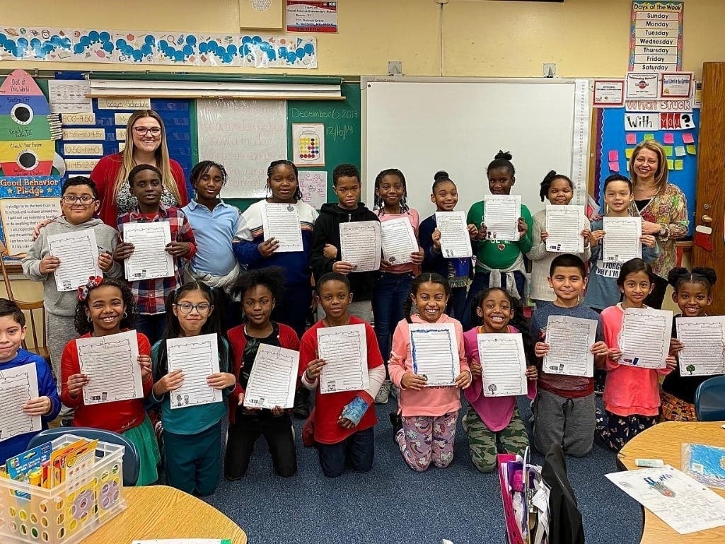 Mrs. Sala’s and Ms. Nardi’s third grade students from the Grand Avenue School pose with their letters that they recently received from their pen pal class in Wisconsin. 