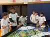(From L-R) East Woods students Kierstin Lore, James Belfi, Logan Taylor, John Michael Allegra, Sam Laserson, Henry Koelmel at the First Lego League (FLL) Regional Competition at Huntington High School testing their City Shaper competition method with thei