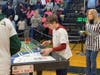 Henry Koelmel at the First Lego League (FLL) Regional Competition at Huntington High School competing with the robot his team and him built. 