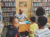 NYT Best-selling author, Kwame Alexander, signing copies of his popular book titled “The Undefeated”, and giving them out to Smith Street Elementary students.