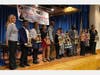 Northern Parkway Elementary School scholars standing on stage after delivering remarks about popular cultural topics and being awarded as champions of the 2nd Annual Uniondale Elementary School Debate Competition.