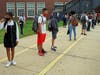 R.M. Finley Middle School students observe social distancing while waiting to enter the middle school building on the first day of school.