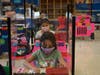 Elementary students back in school behind desk shields, wearing masks, ready to learn.