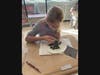 : Isabella Dilgard-Clark, Grade 5, observing how her worm thrives in moist, damp soil, as opposed to dry soil. 