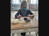 Oliver Smith, Grade 5, watches how his worms eventually make their way towards the small piece of black construction paper in order to be away from the sunlight. 