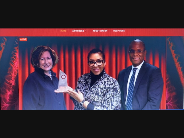 Ms. Felicia Thomas-Williams, Principal of West Middle School, pictured with her award of recognition.