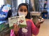 A third grade student with her own copy of ‘Rory’s Adventure Through the Cardiovascular System’