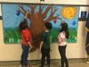 Connolly students that demonstrated leadership qualities imprinting their hands on the “7 Habits Tree,” a representation of how they have made their stamp on the school community.