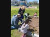 Lawrence Early Childhood students planting pansies, donated by Assemblywoman Melissa Miller, outside of the Lawrence Early Childhood Center.