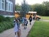 Landing Elementary students coming off the buses as they arrive at school.