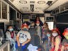 Students pose inside the ambulance as they learn about emergency procedures.