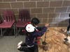 A 4th grade Landing student handles an authentic tool replicating what Native Americans used to drill and make fire.