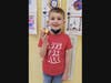 A Wood Park Elementary student takes a bite of his red snack for Red Ribbon Week.